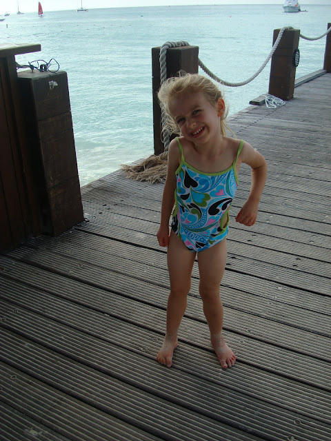 Young girl making silly smile standing on pier
