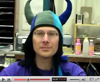 science teacher explains global warming while wearing a funny hat