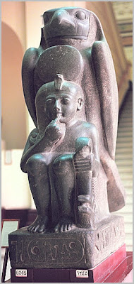 من روائع المتحف المصرى (2) Ramses+II,+19th+dynasty,+shown+as+child+in+front+of+the+Horus+figure.