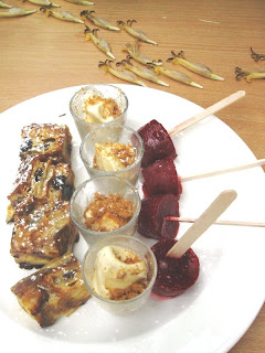 Four bite-size portions of bread pudding, ice cream and berry ices