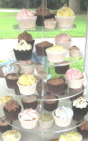 A tiered stand of pastel-coloured cupcakes