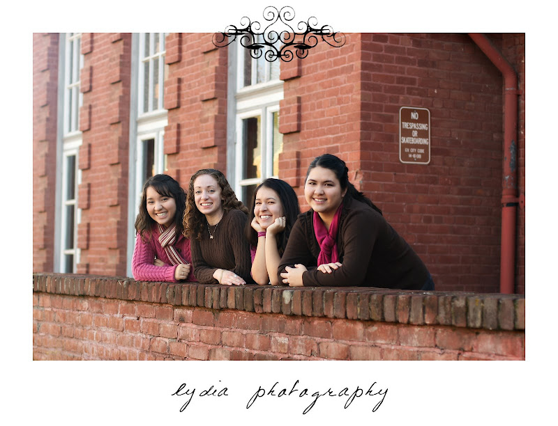 Girls leanning on a brick wall at lifestyle friends portraits at the Elks Lodge in Grass Valley, California