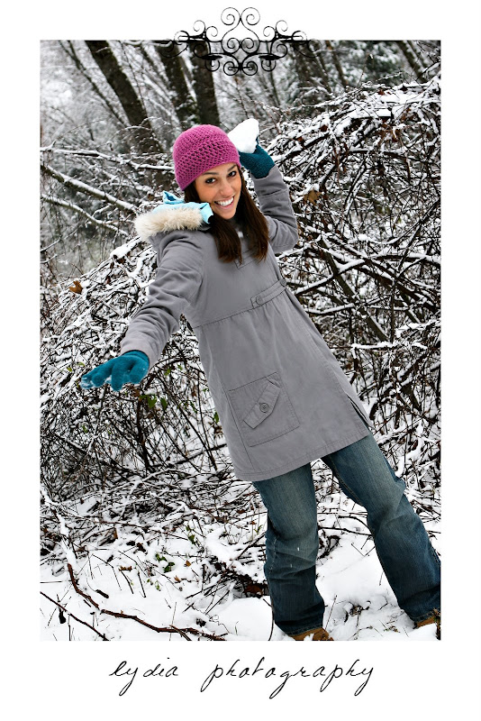 Girl throwing a snow ball at the camera at snow lifestyle fashion portraits in Grass Valley, California