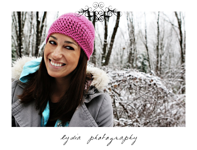 Girl smiling at the snow covered trees at snow lifestyle fashion portraits in Grass Valley, California