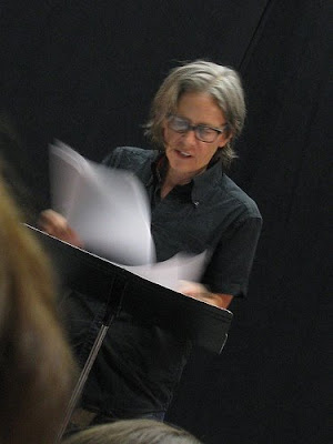 Eileen Myles reading at a lectern