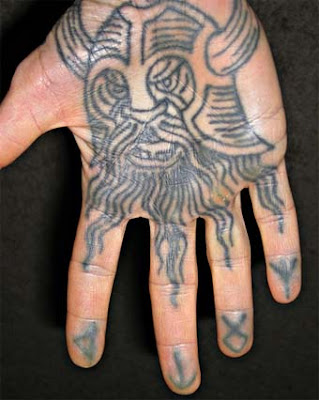Christian tattoos: Wearing faith on your half-sleeve. Viking skull on the