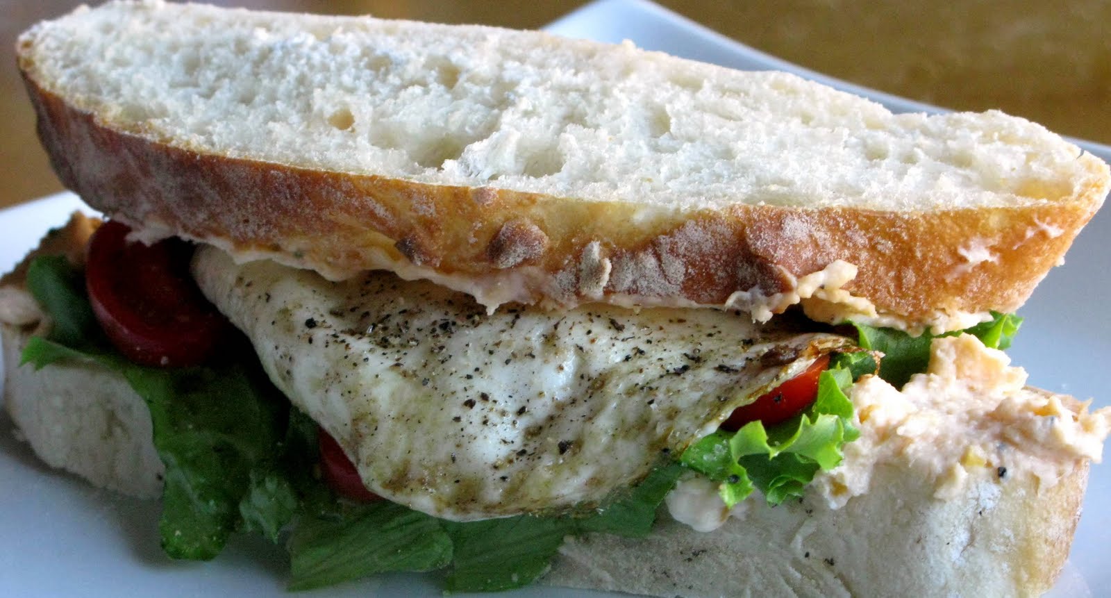 Fried Egg Sandwich with Cream CheeseCheddar Spread Sprinkled with Flour