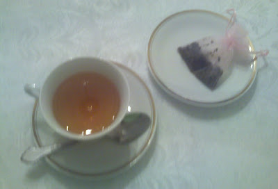 brewed loose tea and used tea sachet