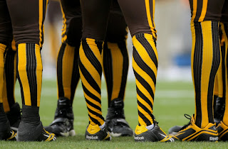 This is a photograph of the throwback uniforms the Denver Broncos wore in a game against the New England Patriots.