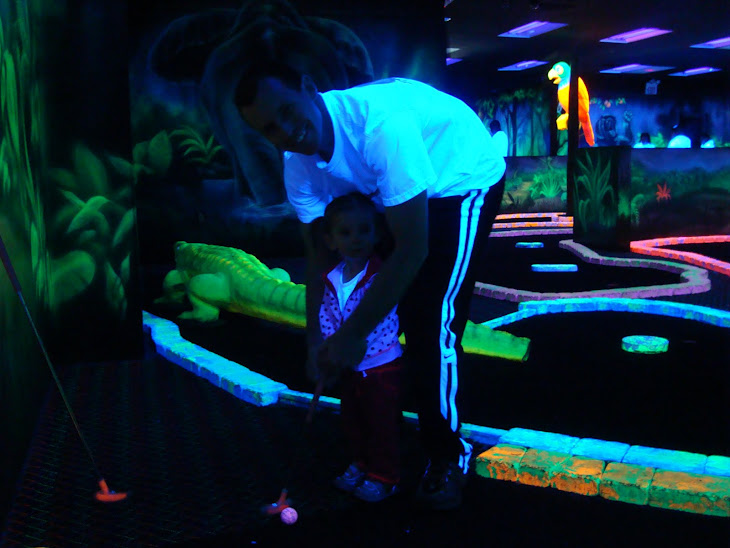 We took Daddy Blacklight Putt Putting for his Birthday. He is teaching me my swing!