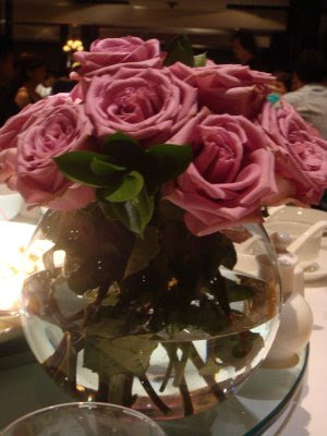 the centerpieces at the wedding were lovely the roses really complimented 