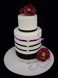 Extended base tier cake,with Mother of Pearl  buckle ribbons, with sugar peony roses..