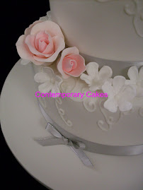 3 tier white stacked sugar blossom and sugar  roses with piped detail cake.