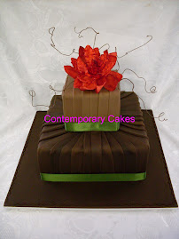 Red sugar magnolia and dodi vine chocolate sugarpaste panelled cake for a 75th birthday