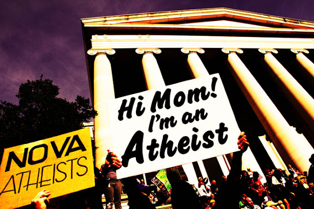 A guy at the Rally to Restore Sanity and/or Fear in Washington D.C. with a sign that says, "HI Mom! I'm an Atheist".