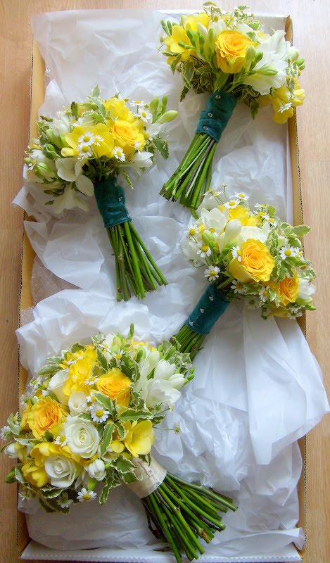 The bridesmaids carried smaller versions bound with teal ribbon
