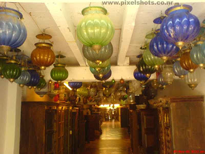 colourful wall lamps or candliers for sale in an antiques shop in cochin jew street of india cochin kerala