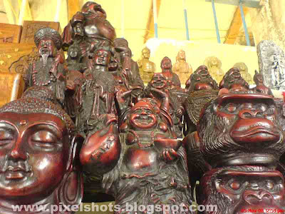 sculptures made in clay,lord buddha etc are sculptured and put for sale in street shop in mattancherry cochin