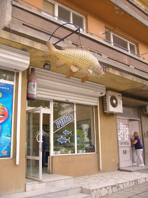A Dangling Carp Outside A Yambol Fishmonger's Shop