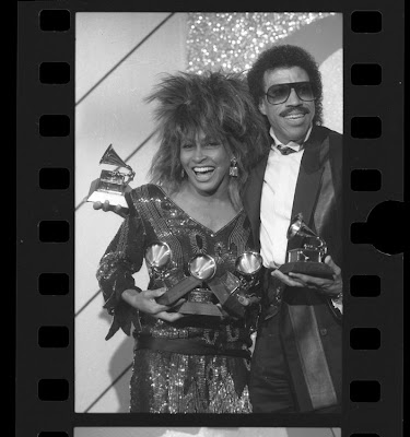 Singers Tina Turner and Lionel Richie posing with their Grammy Awards