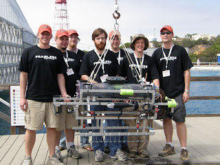 Team posing with vehicle