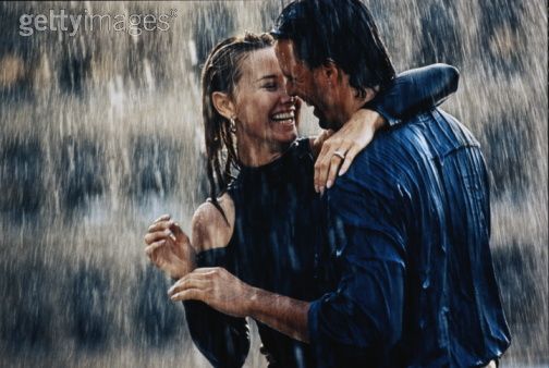 romantic couple kissing in the rain. couple kissing in rain. couple