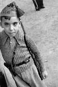 Robert Capa, Spanish Civil War, Barcelona 1936. The boy is wearing a cap of .