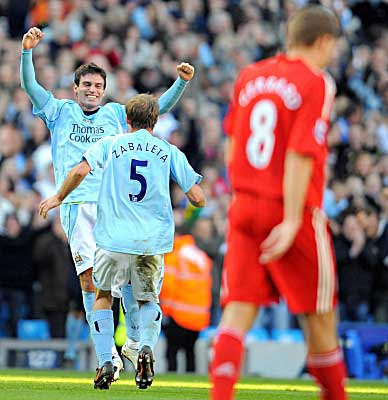Manchester City's Javier Garrido (left) celebrates with teammate Pablo Zabaleta after scoring the second goal against Liverpool.