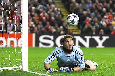Iker Casillas of Real Madrid watches the ball as he dives to make a save during the UEFA Champions League Round of Sixteen, second-leg match between Liverpool and Real Madrid at Anfield on March 10, 2009 in Liverpool, England.