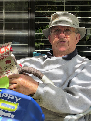 Papa Marks sitting in his chair on the porch with his birthday presents