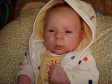 Our little boy in his giraffe outfit at four weeks