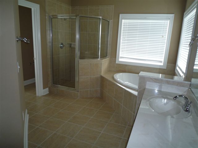 More Master Bath with jetted tub, shower, and toilet room to back left