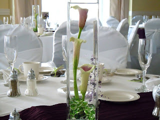 Guest table centerpiece on Eiffel Tower vase with white dendrobium