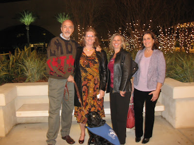 Fred, Cheryl, Stephanie and Nancy stand in front of the beautiful lit trees of the Mahaffey Center. HRH is in front of us seated.