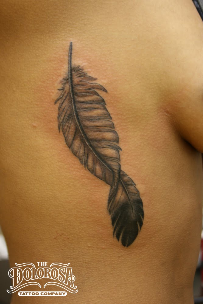 Little black and grey feather tattoo. This was her first one and she sat 