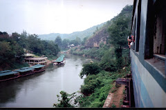 Travelling on the train and crossing the "DEATH RAILWAY BRIDGE" on river Kwai.