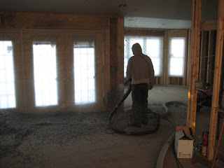 picture of man spraying nu-wool cellulose insulation