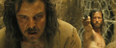 The Proposition: Will Charlie pull the trigger on Arthur? Guy Pearce as Charlie, Danny Huston as Arthur