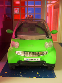 Modern miniature Kaleidoscope doll's house car port with Smart car.