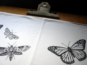 Art board covered with a pillowcase with butterflies printed on it.