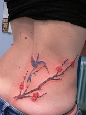 bird lower back tattoo women