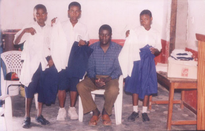 PASTOR GIVING THE CHILDREN UNIFORMS.