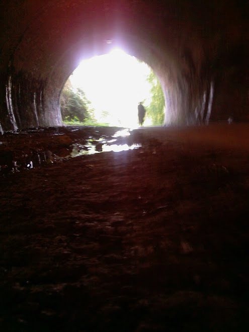 CYCLIST AT THE END OF A TUNNEL