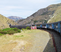 Train exiting one of 19 tunnels and crossing a viaduct