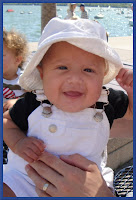 cute smiling baby wears sun hat photo