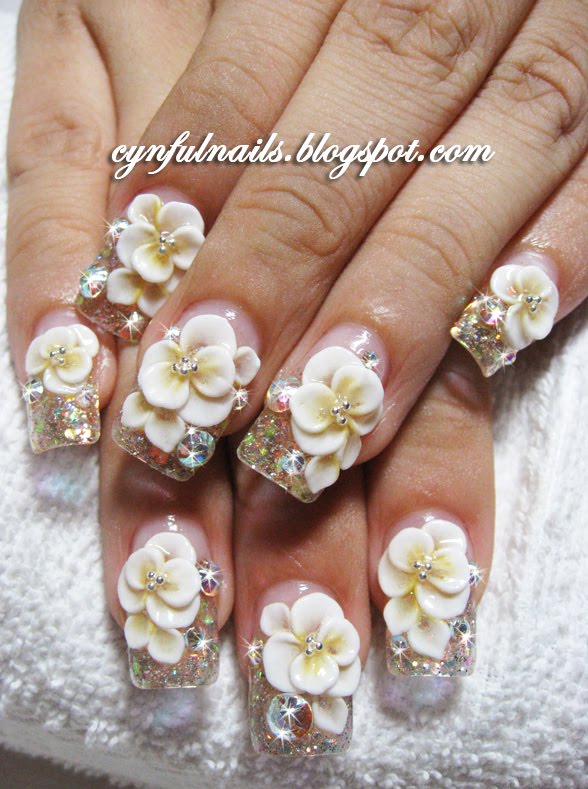 Champagne glitter gel and white flowers with a tinge of yellow