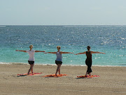 Some of the local girls seen here serene on the beach in the early morning . (yoga on the beach)
