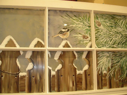 Chickadee in winter on window