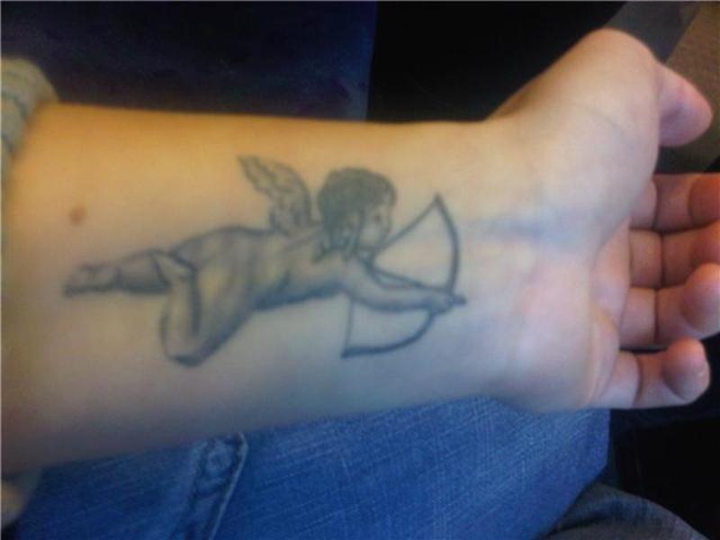 Boy angel with bow tattoo.