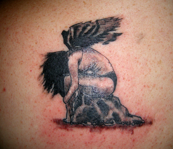 Angel Tattoos For Men Fallen angel on rock tattoo.